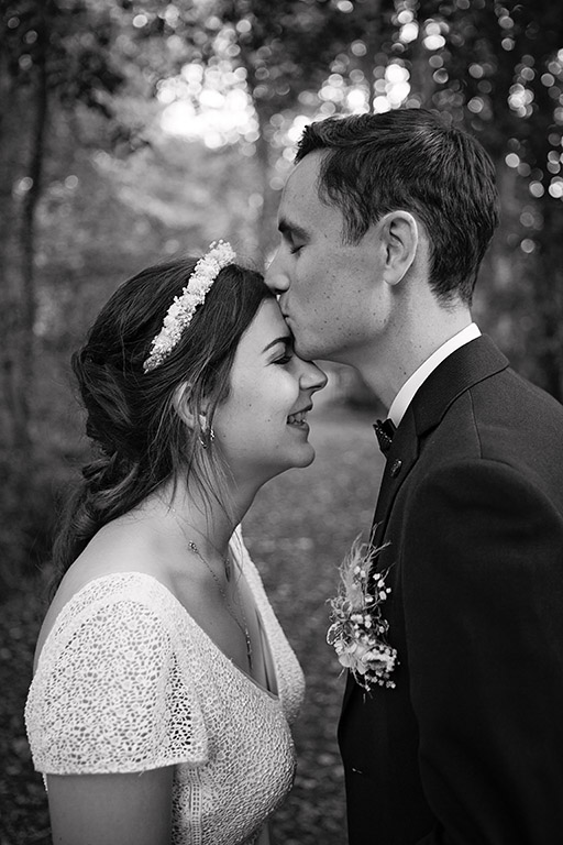 Une séance photo couple en noir et blanc, un couple qui s'embrasse sur le front tout en émotion